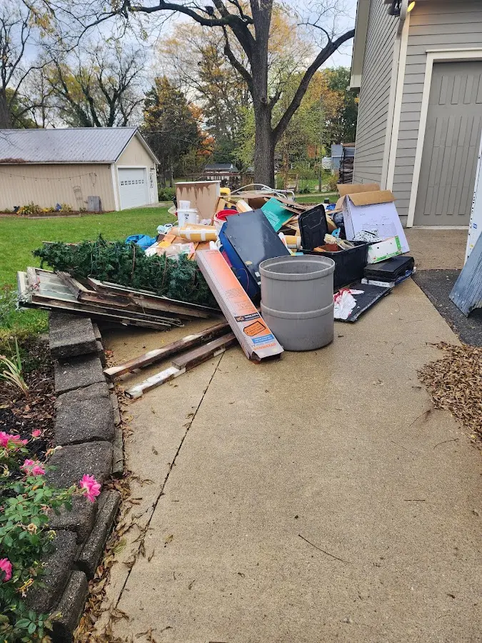 Dumpster being loaded with debris for Estate Cleanout Dumpster Rental in Laureldale